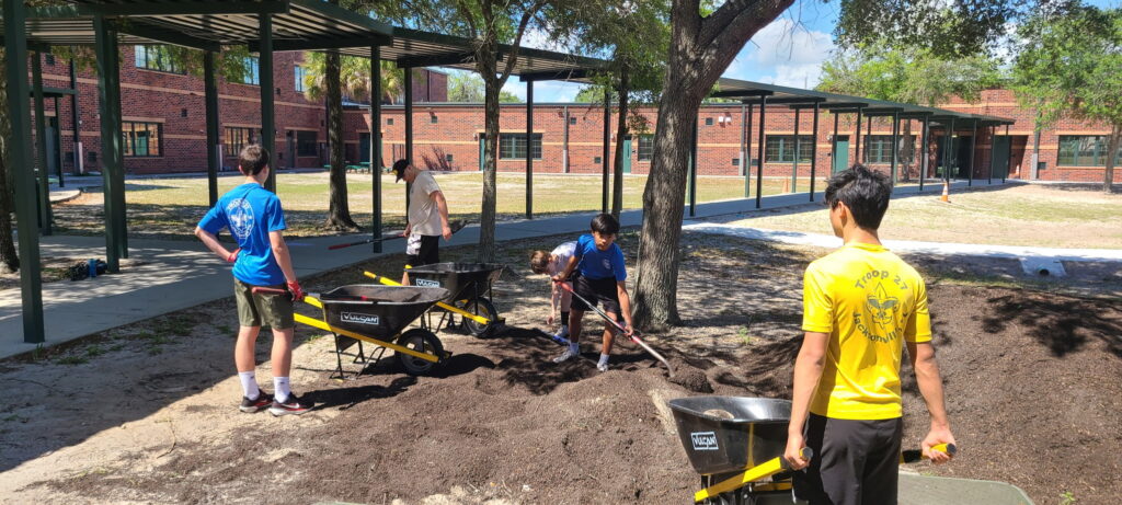 Students shovel dirt at North Shore Elementary